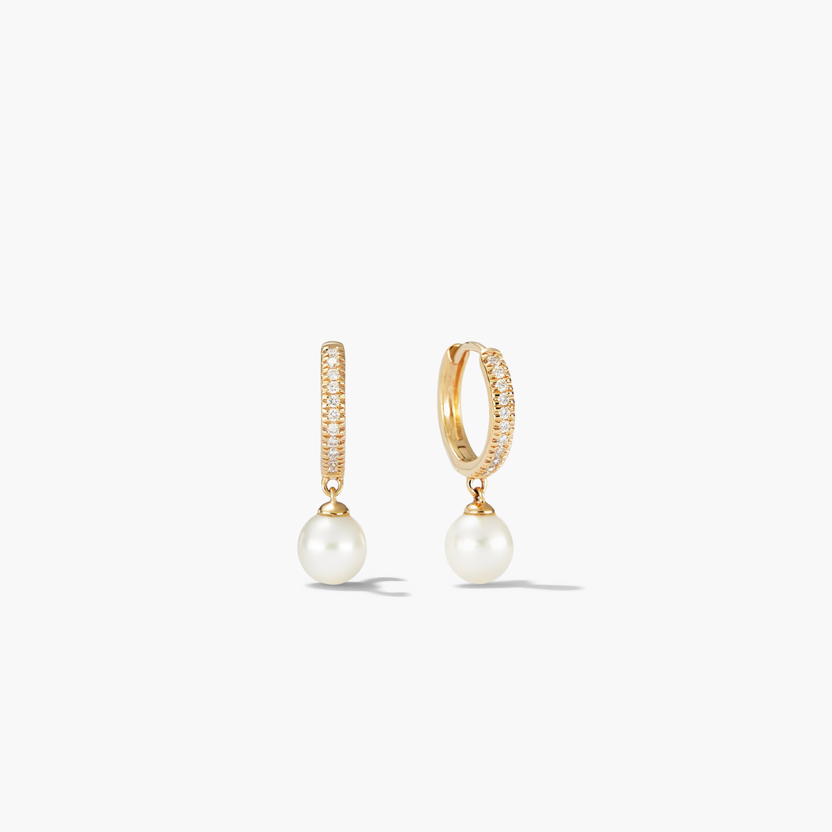 PavÃ© Diamond Pearl Huggies: 14k gold earrings with 22 pavÃ©-set diamonds and a round freshwater pearl, elegantly designed for versatile wear.