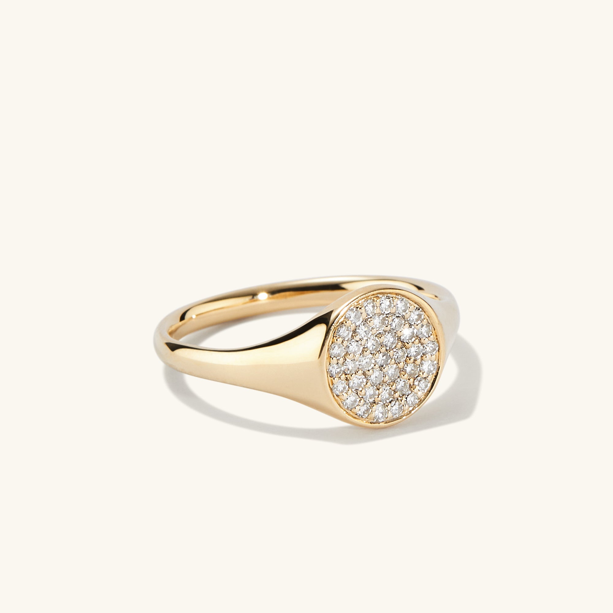 PavÃ© Diamond Signet Pinky Ring featuring intricate gold craftsmanship adorned with sparkling diamonds, highlighting its elegant design and luxurious appeal.