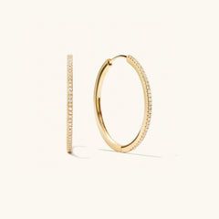 PavÃ© Diamond Large Hoops: A pair of handcrafted 14k solid gold hoop earrings with pavÃ© diamonds, designed for versatile wear.