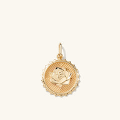Strength: Rose Coin Charm Pendant featuring a detailed gold rose medallion, symbolizing strength and new possibilities, expertly handcrafted in recycled 14k solid gold.