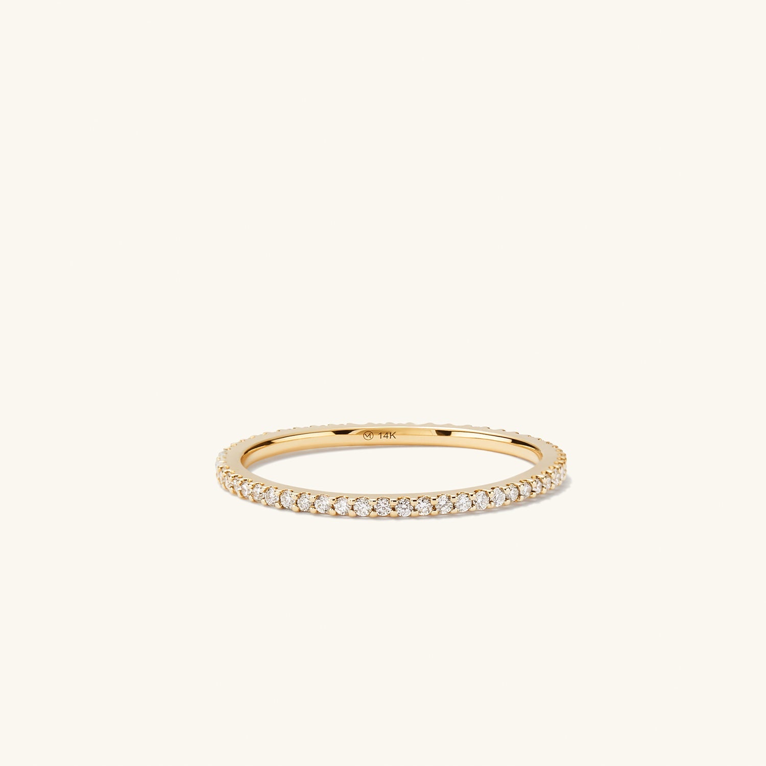 Slim Diamond Eternity Band: a close-up of a slim gold ring featuring a continuous circle of hand-set diamonds in open prongs, showcasing its elegant sparkle.