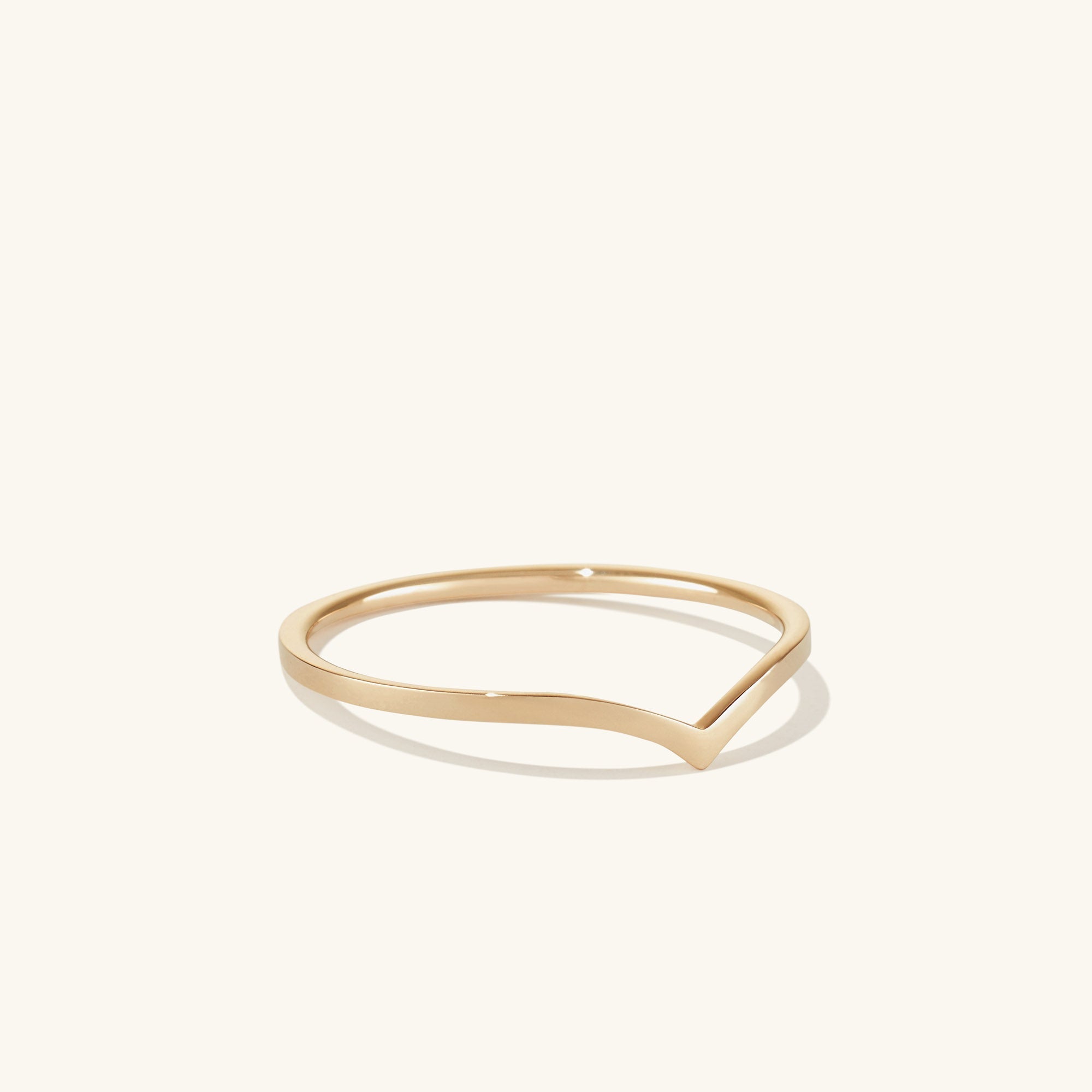 Wishbone Stacker Set featuring a gold ring with a curved edge and a matching gold bracelet, designed for a stylish ring stack.