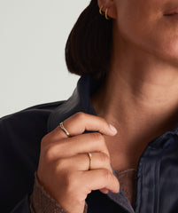 Close-up of a woman's hand wearing a Baguette Stacker Ring, showcasing the detailed design of the ring on her finger.