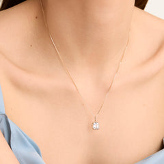 Woman wearing the Baby Box Chain Necklace, a delicate, light box chain that catches the light perfectly, highlighting its elegance as a classic fashion accessory.