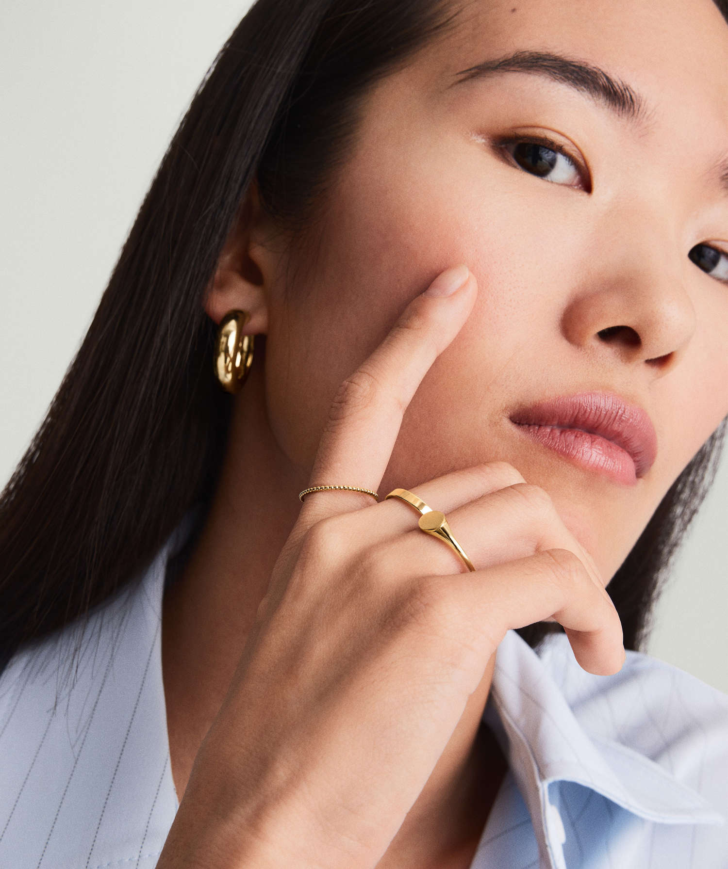 Woman showcasing the Beaded Ring on her finger, highlighting its 14k white gold and rhodium-plated finish. The ring is durable and 1.3 mm thick.