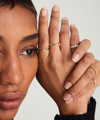 Close-up of a woman's hand showcasing a Bold Chain Ring, inspired by chain necklaces, handcrafted in hollowed 14k solid gold.