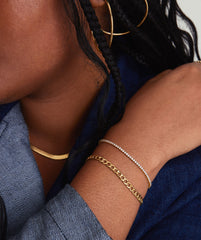 Diamond Tennis Bracelet 1.8mm on a woman's wrist, showcasing its sparkle and intricate design with secure clasp mechanism, handcrafted in 14k solid gold and diamonds.