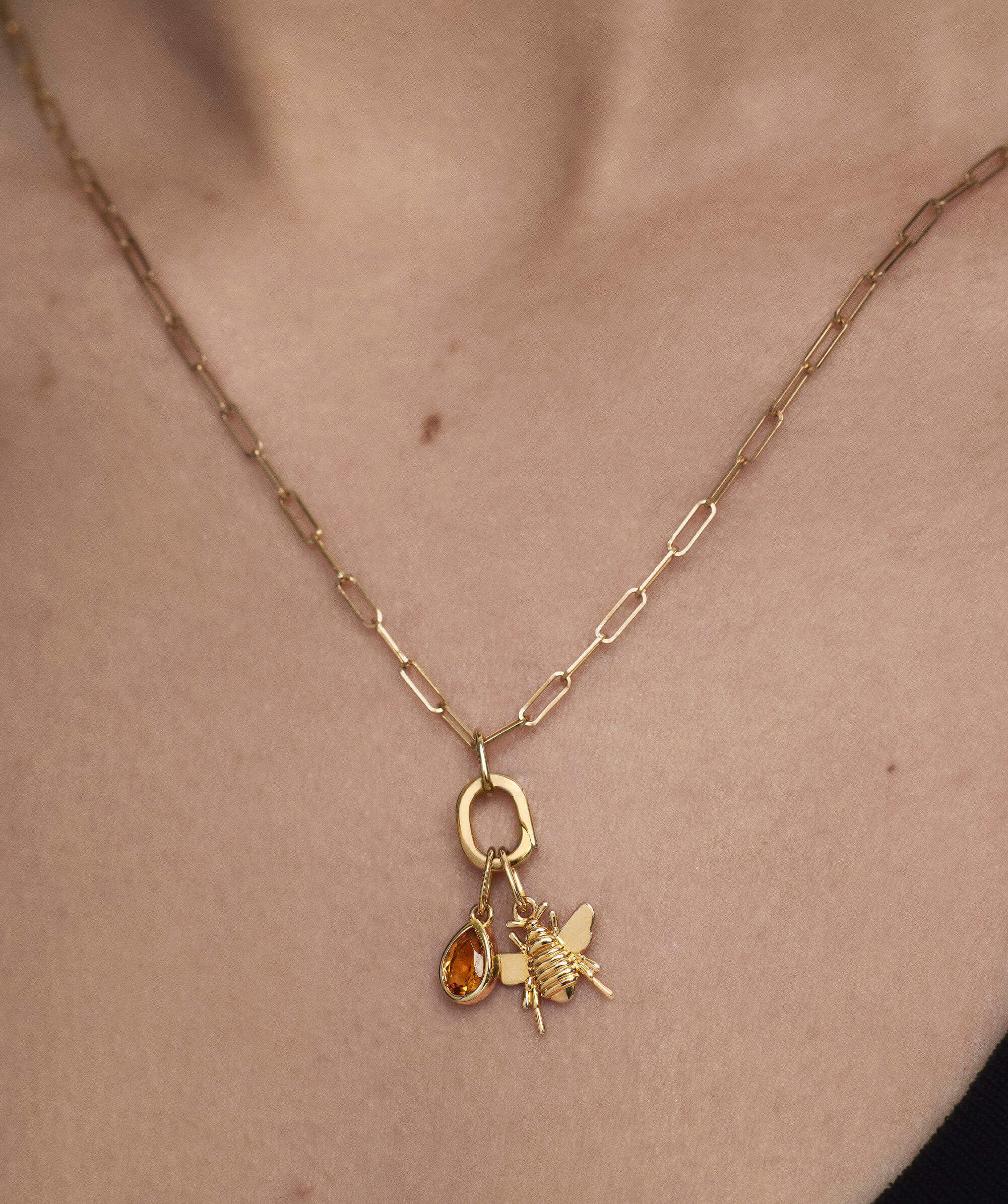 Small Pear Pendant showcased on a gold necklace, featuring a detailed close-up of a bee and gem, enhancing its everyday elegance.