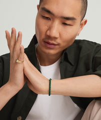 Man wearing a 4mm Gemstone Beaded Bracelet, featuring handcrafted sterling silver beads and a swivel clasp, on his wrist.