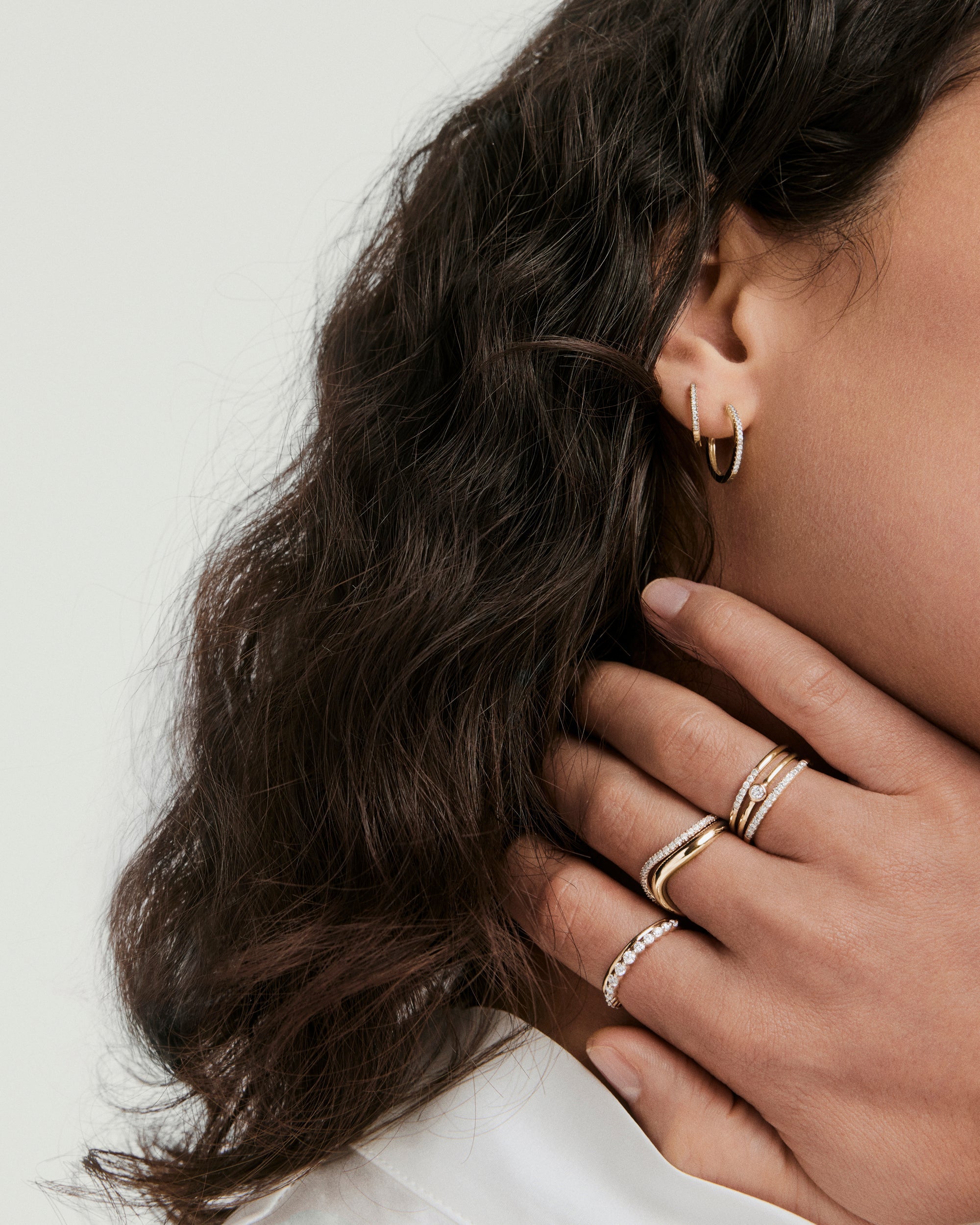 Close-up of a woman's hand showcasing the Lacey Lab Grown Diamond Ring, featuring graduating stones that enhance its elegance and dimension.