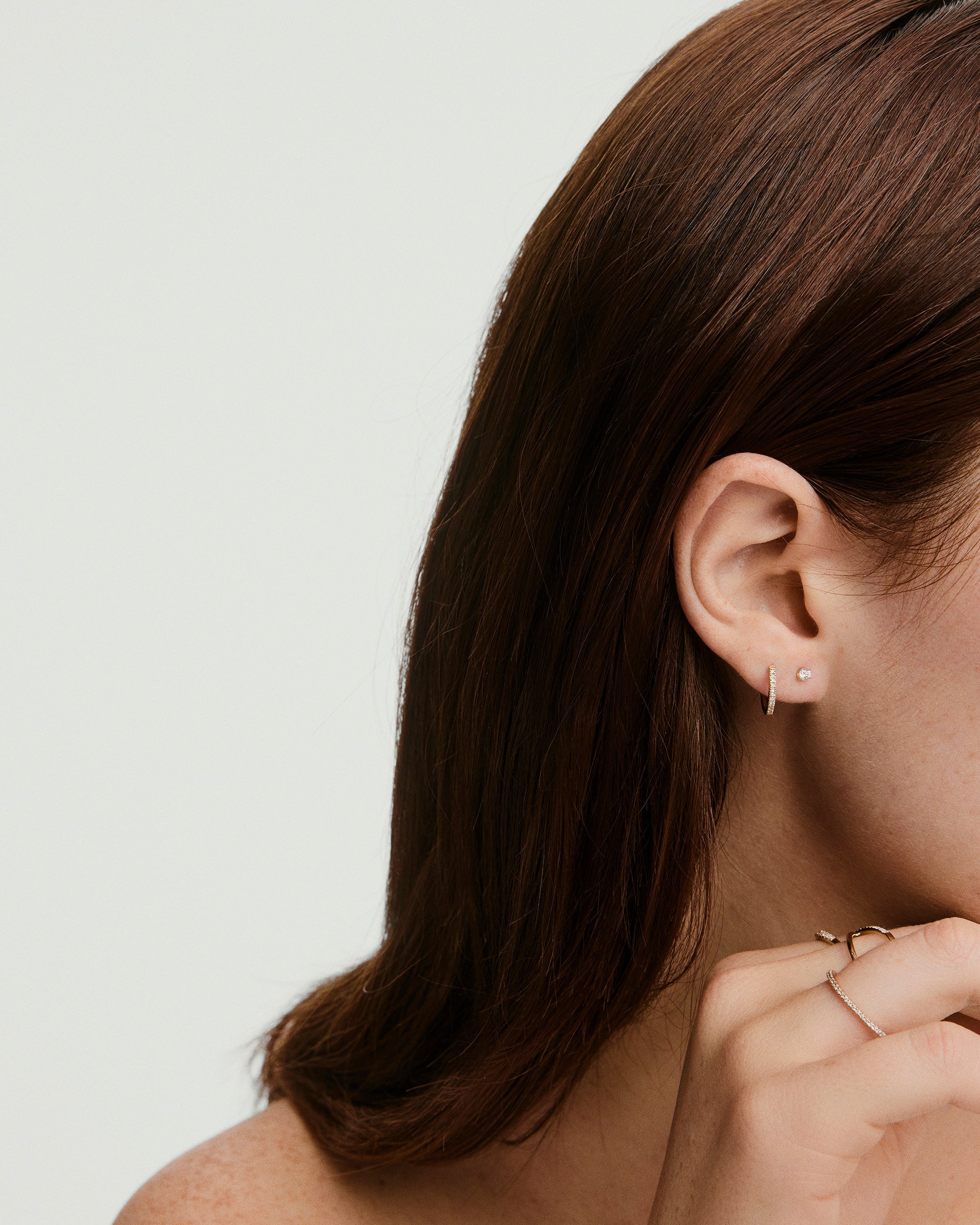 Diamond Mini Studs in a prong setting, perfect for stacking. Designed for comfort with flat back studs, suitable for healed piercings. Includes two post sizes.