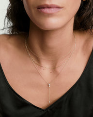 Woman wearing Celeste Lab Grown Diamond Lariat Necklace, featuring a cluster of diamonds and a drop chain for a constellation-like sparkle.