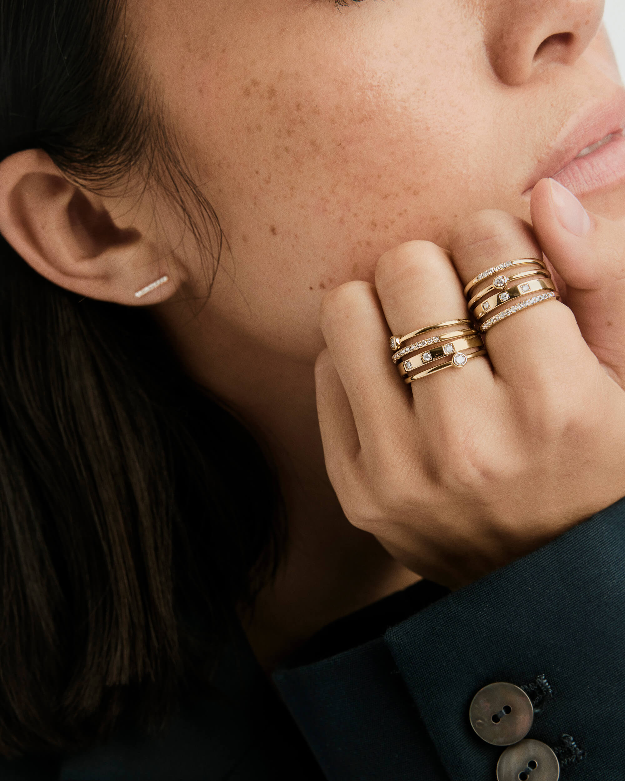 Close-up of a woman's hand adorned with a 14k solid gold Diamonds Band, featuring small diamonds, showcasing elegant craftsmanship.