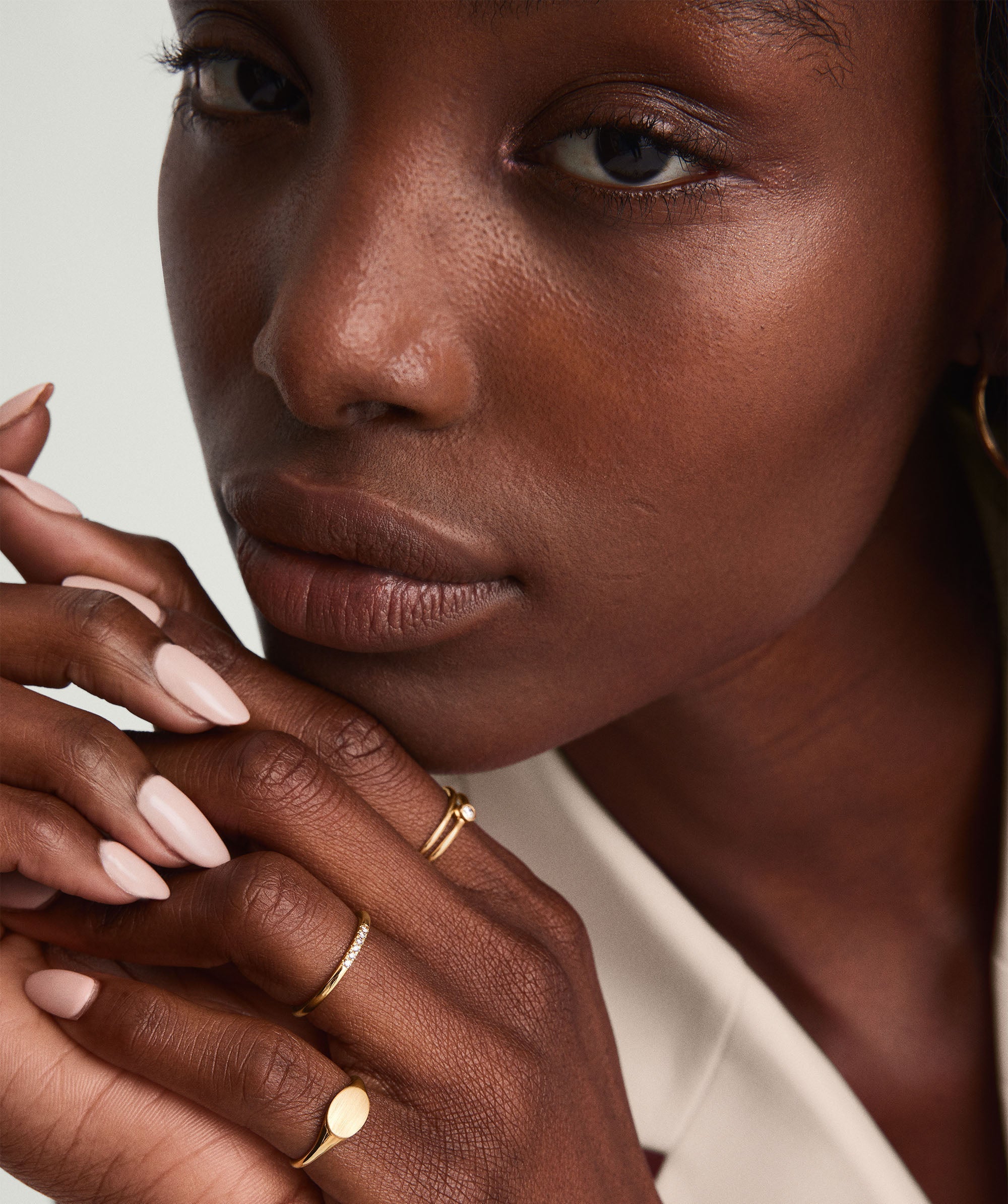 Diamonds Line Ring with six diamonds in a prong setting, worn by a woman. The ring is showcased in a close-up shot of her hand.