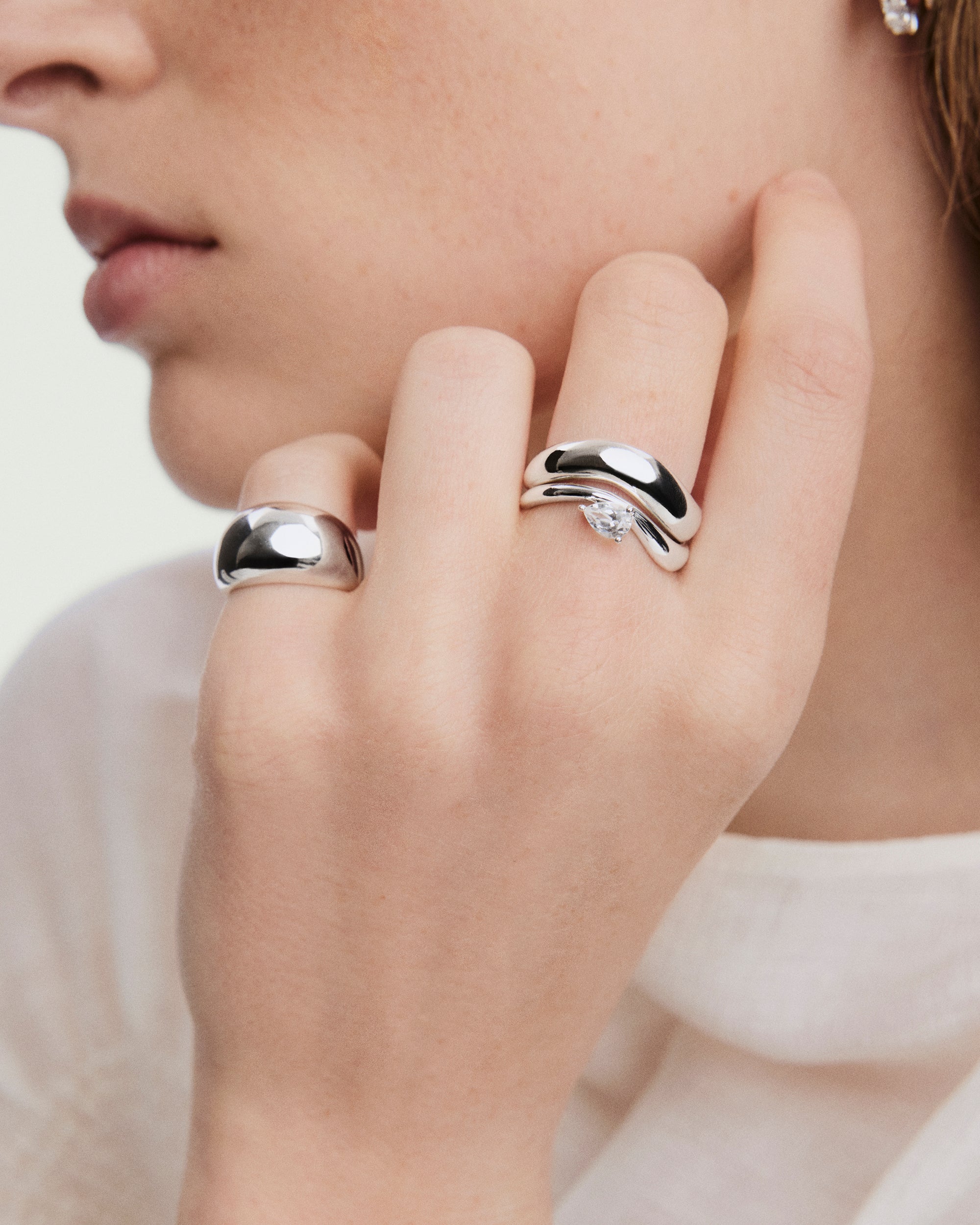 Close-up of the DÃ´me Figure Balance Ring showcasing a pear cut gemstone floating above the band, ideal for layering with other DÃ´me Figure Rings.