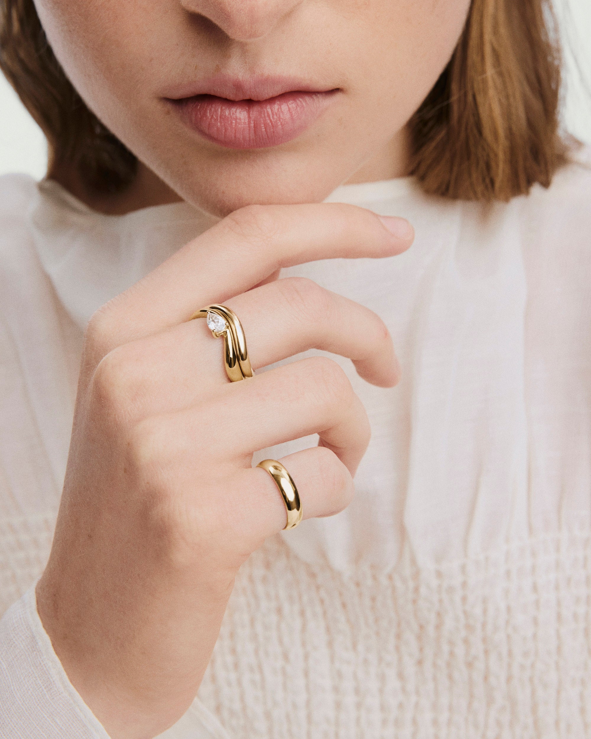 DÃ´me Figure Balance Ring with a pear cut gemstone elegantly floating above its band, ideal for layering with other DÃ´me Figure Rings.