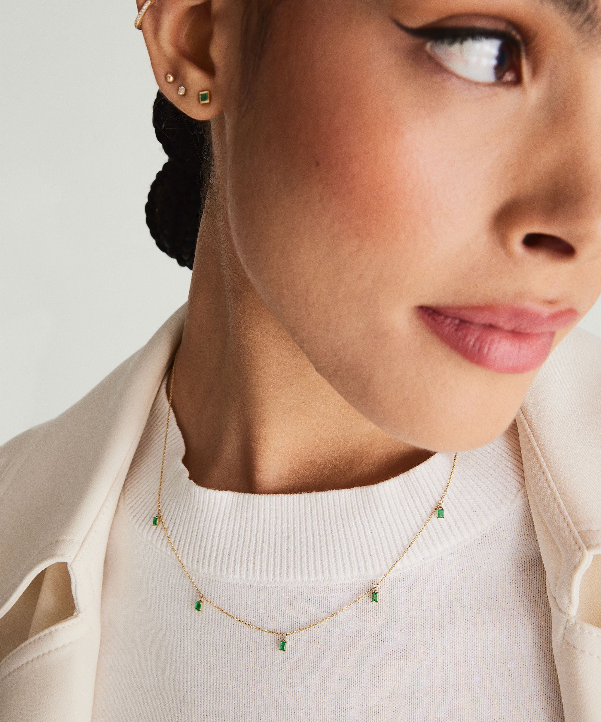 Close-up of a woman wearing the Baguette Gemstone Station Necklace, showcasing its elegant, spaced gemstone design.