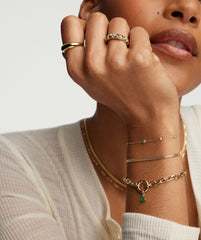 Woman's hand wearing Large Square Oval Chain Charm Bracelet in 14k solid gold, featuring the Stacker Clasp with layered charms.