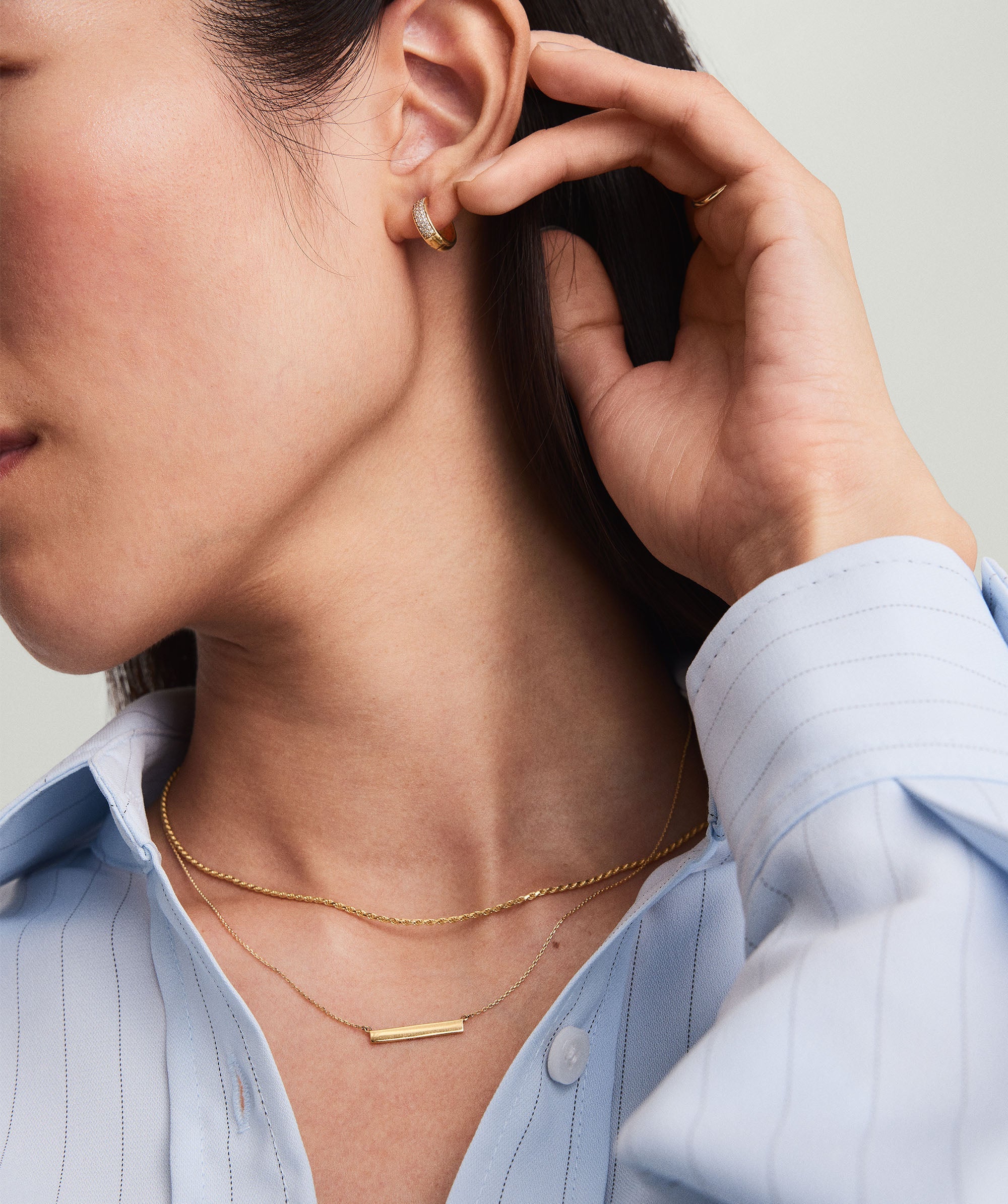 Horizontal Engravable Bar Necklace in 14k solid gold, shown worn by a woman, highlighting its sleek, minimal design and customizable engraving option.