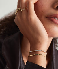 Close-up of a woman's hand wearing the Lab Grown Diamond Tennis Bracelet 1.8mm, showcasing its elegant 14k solid gold and sparkling lab-grown diamonds.