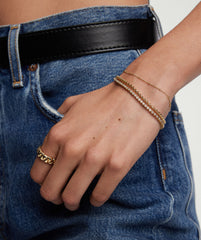 Person wearing Bezel Lab Grown Diamond Tennis Bracelet in 14k solid gold with matching ring.