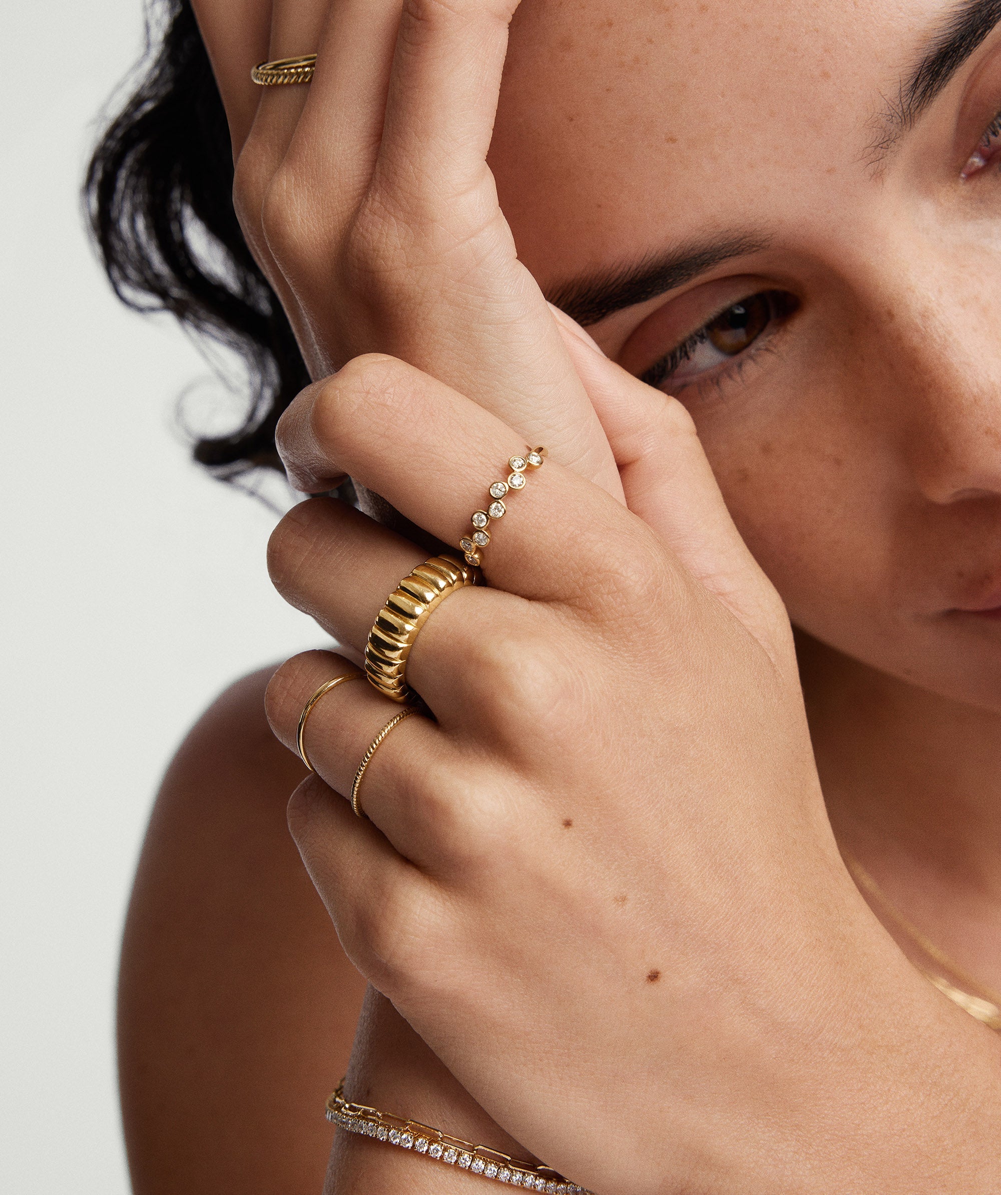 Woman wearing a Bezel Lab Grown Diamond Zig-Zag Ring on her finger, showcasing the intricate design and sparkling diamonds set in 14k solid gold.