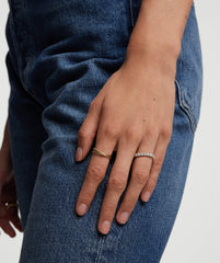 Hand with a 3mm Lab Grown Diamond Eternity Band on a finger, showcasing the sparkling diamonds set in handcrafted 14k solid gold.