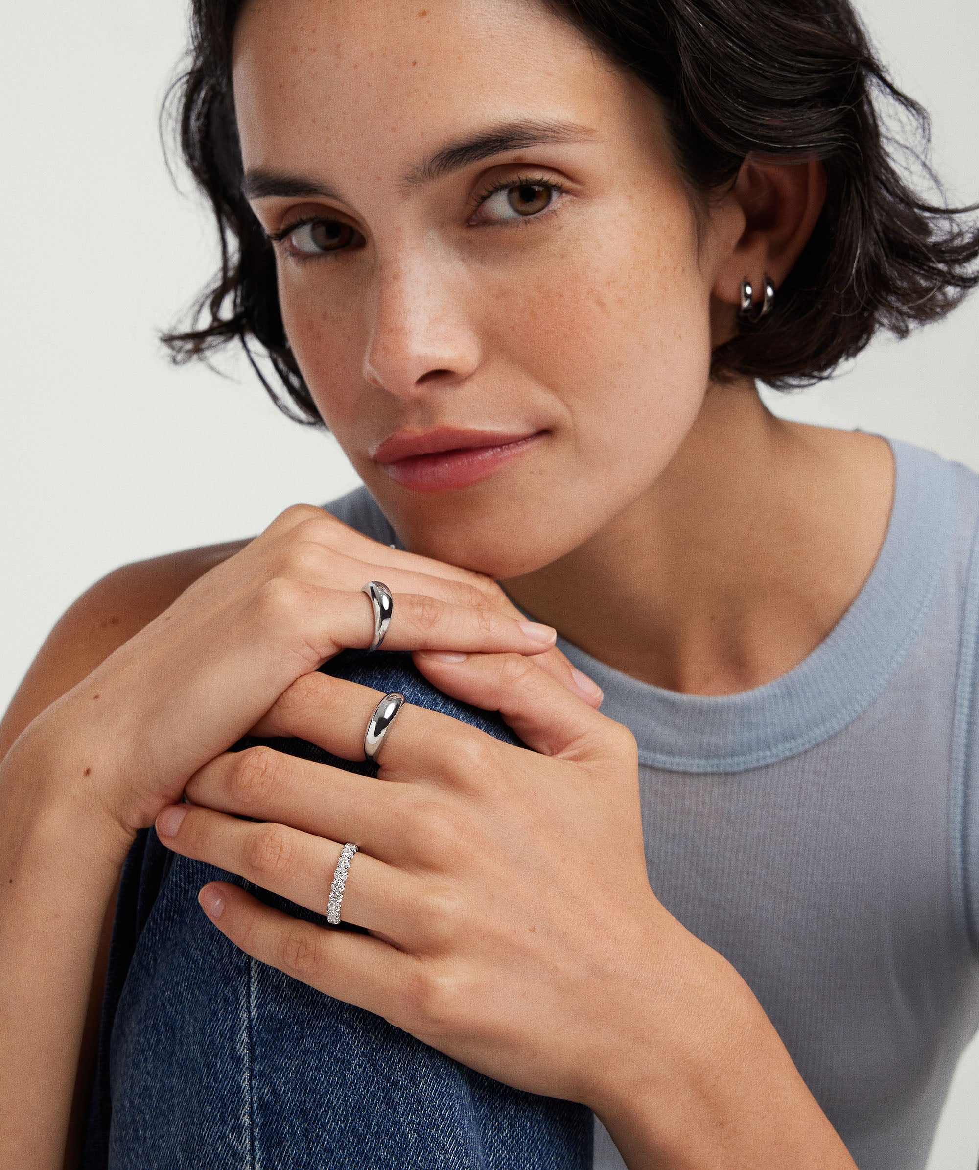 Woman wearing 3mm Lab Grown Diamond Eternity Band on her left hand, showcasing the sparkling ring crafted in 14k solid gold with lab-grown diamonds.