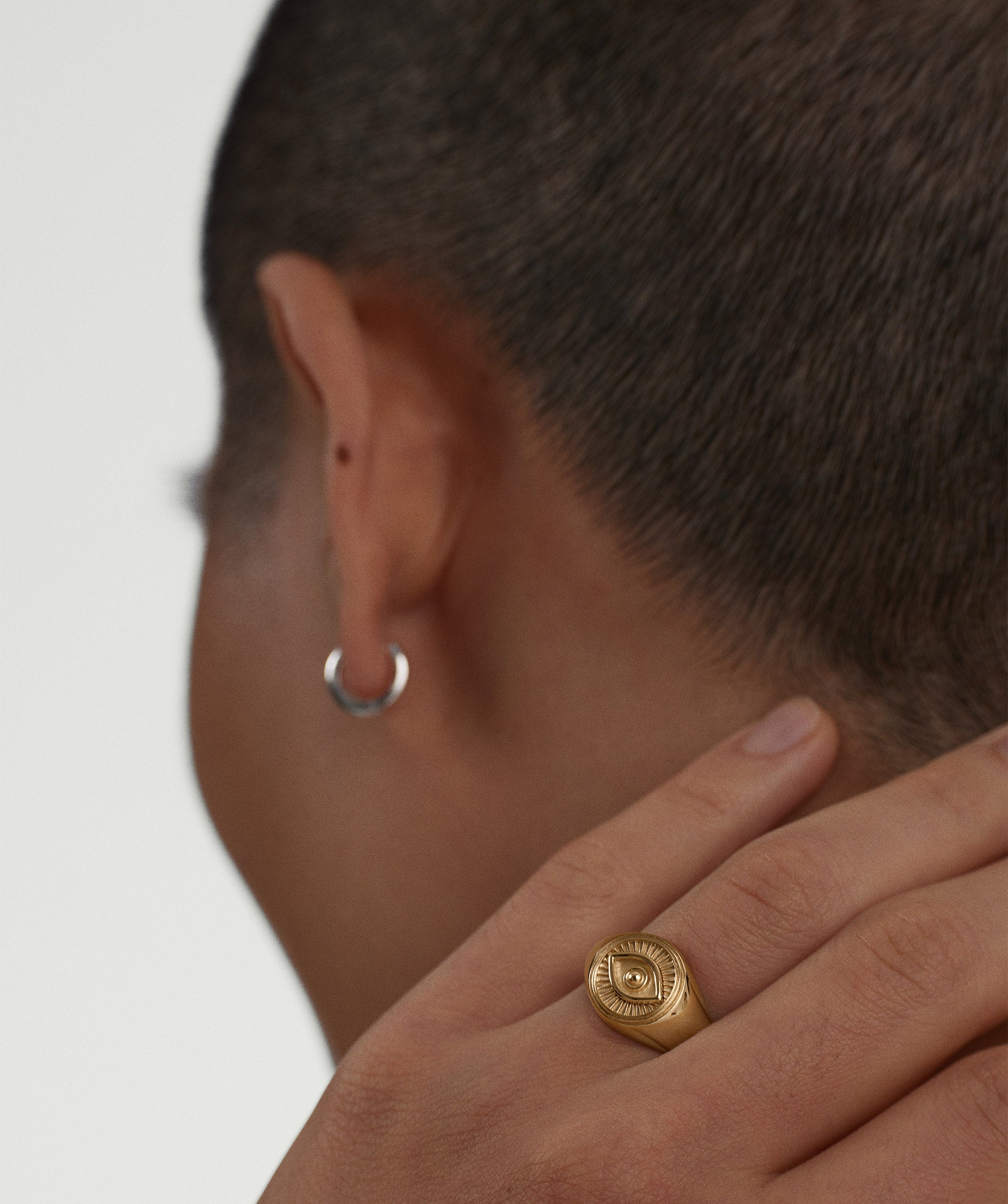 Person wearing the Courage Signet Ring featuring the evil eye symbol, designed to ward off negative energy, highlighting its cultural significance and protective purpose.