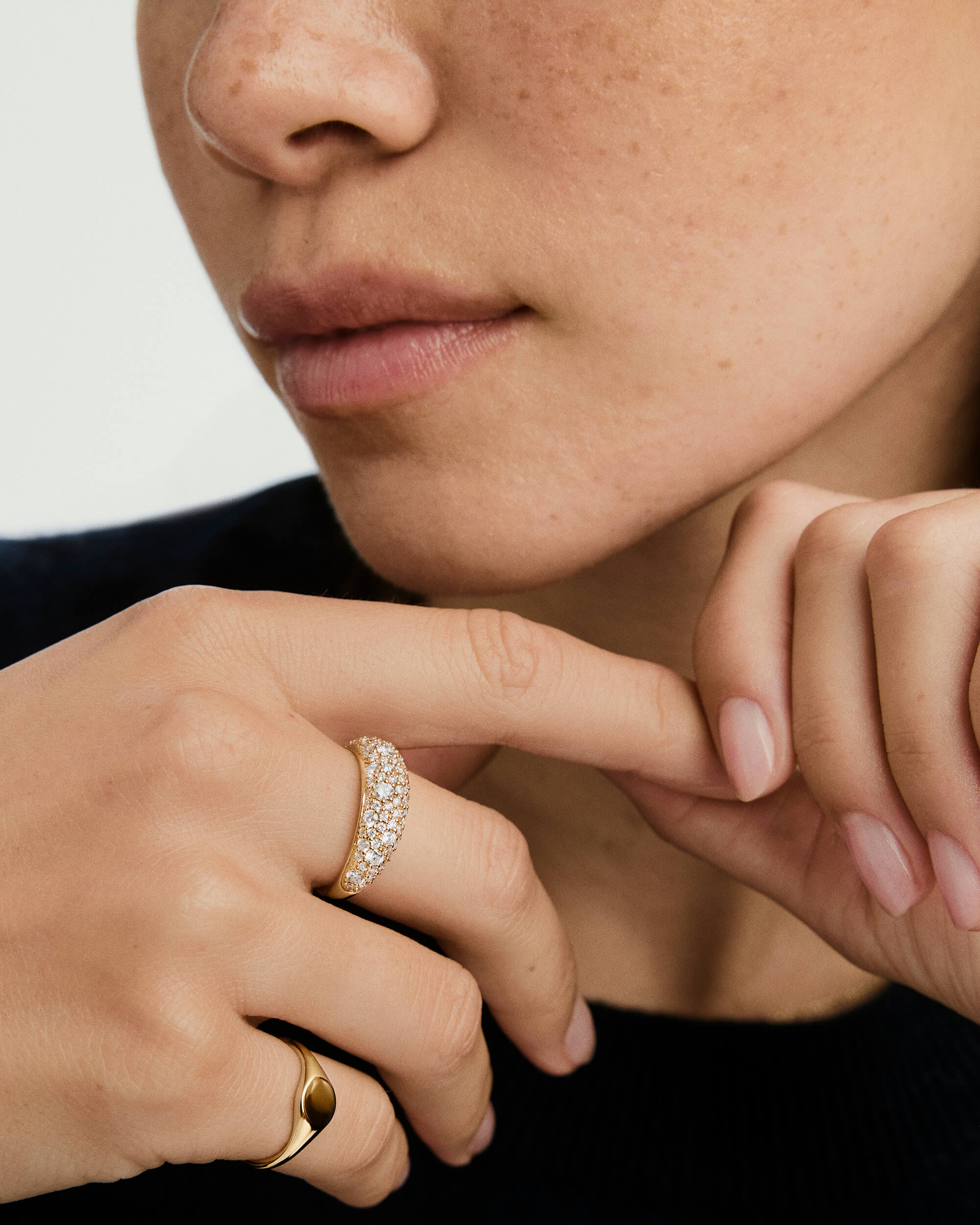 DÃ´me PavÃ© Lab Grown Diamond Ring on a woman's finger, showcasing a dense cobblestone setting of lab grown diamonds for a smooth, unbroken shine.