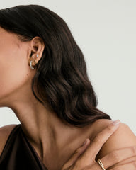 Close-up of a woman wearing Lab Grown Sapphire Small Hoops, highlighting the earrings' elegant design and subtle shine.