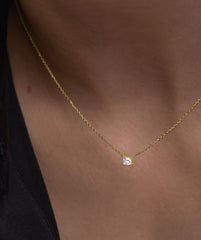 Person wearing Lab Grown Sapphire Baguette Necklace, featuring an emerald cut sapphire pendant on a gold chain, highlighting its elegant design for everyday wear.
