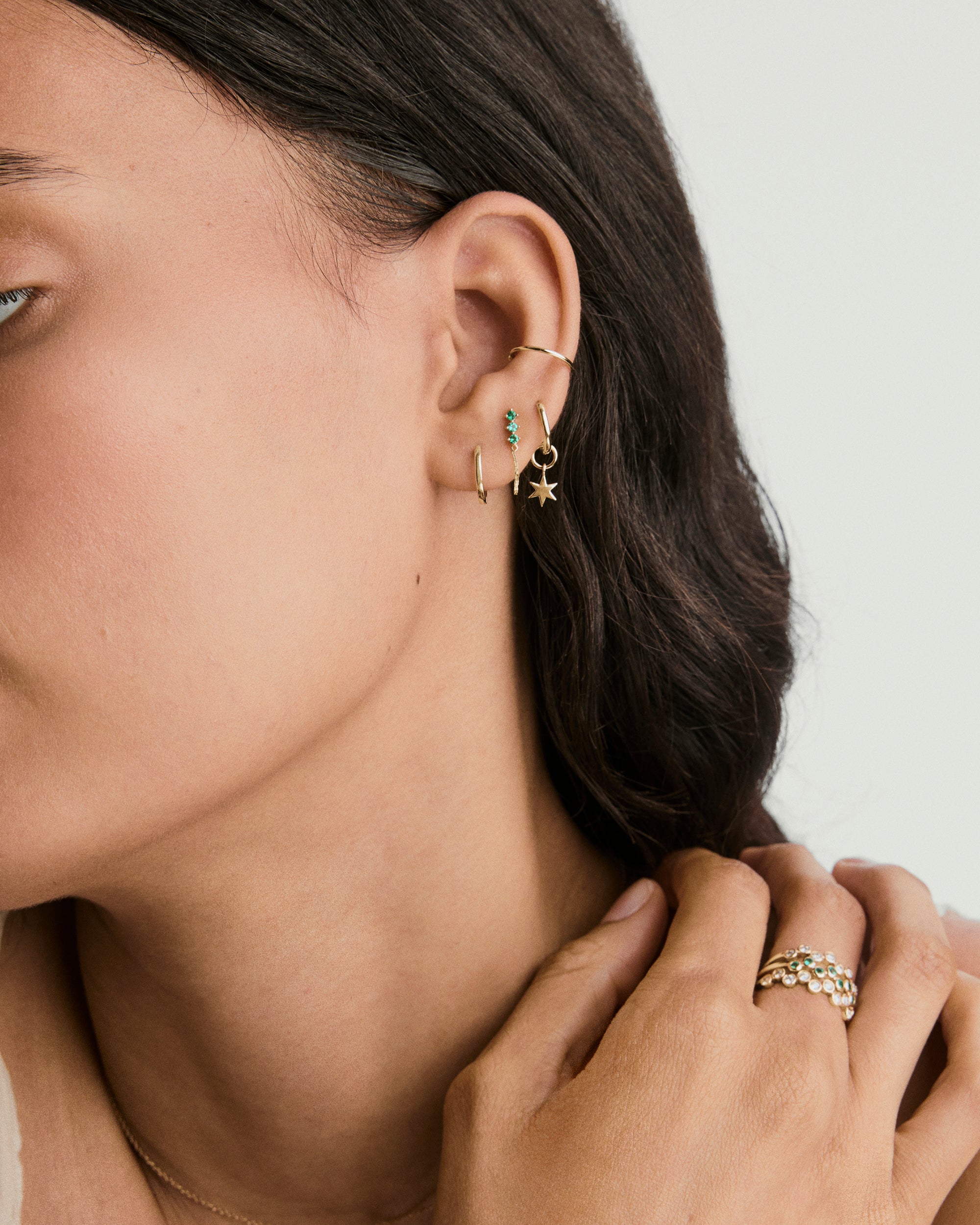 Trio Chain Stud on a woman's ear, featuring a chain design with lab-grown gemstones, perfect for customizable ear stacking and versatile styling.