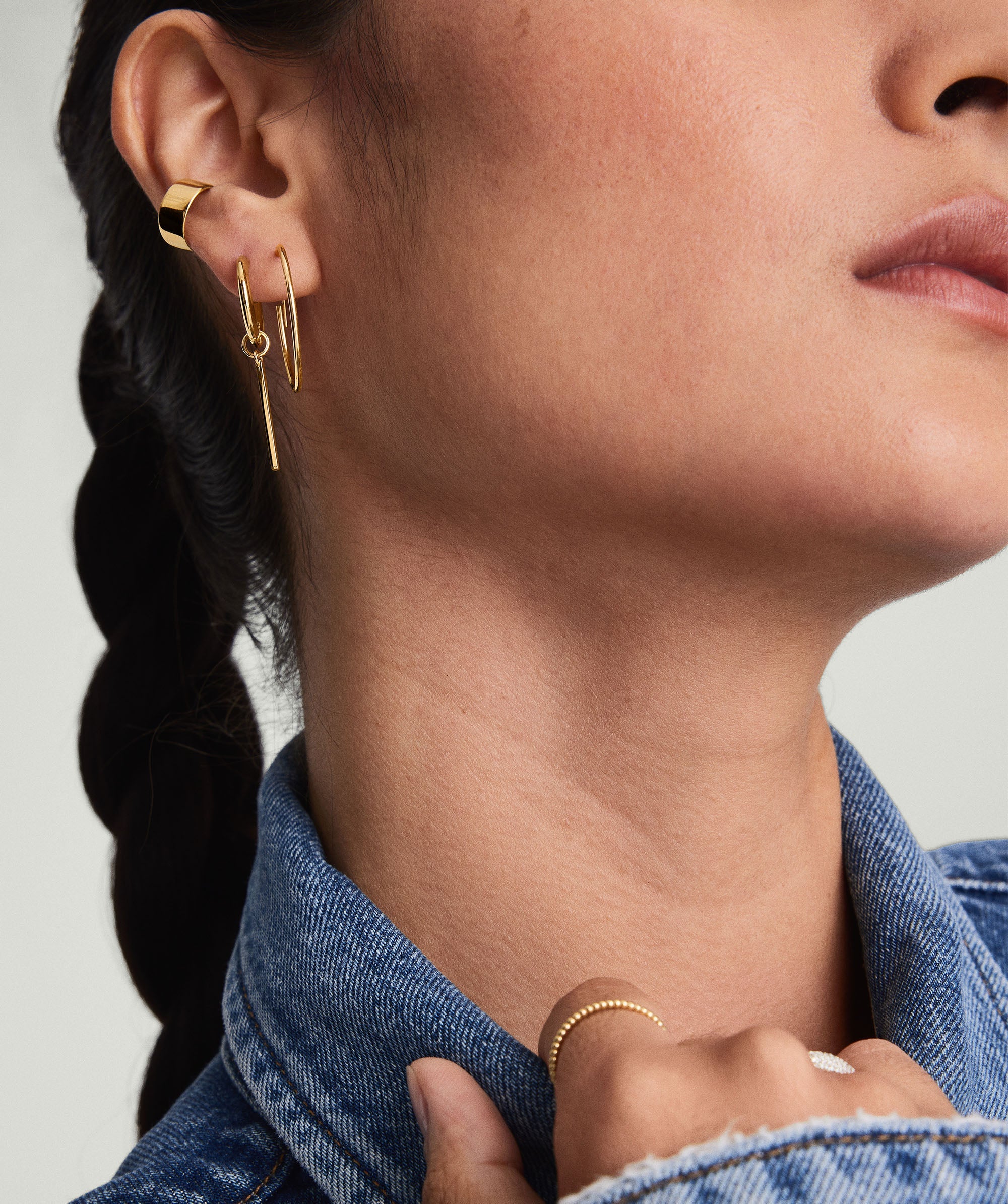 Close-up of a woman wearing Large Hoops, handcrafted in 14k solid gold, highlighting their lightweight design ideal for daily wear.