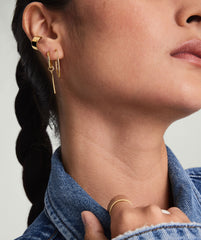 Close-up of a woman wearing Large Hoops, handcrafted in 14k solid gold, highlighting their lightweight design ideal for daily wear.