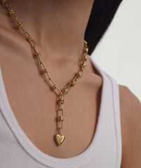 Woman wearing Multi Way Chain Necklace, showcasing its versatility with customizable lengths and charms, highlighting its unique design and fashion-forward appeal.