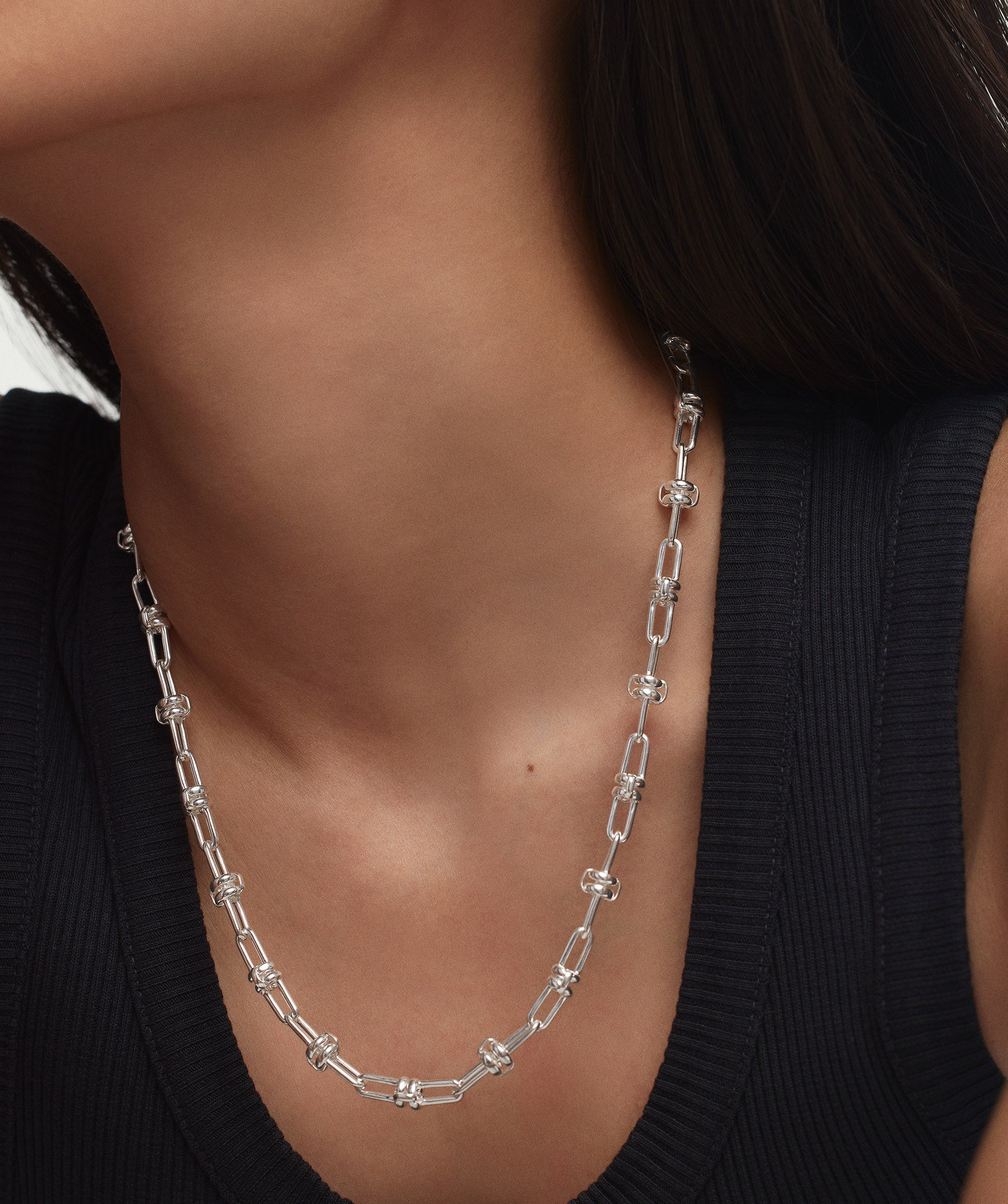 Woman wearing Multi Way Chain Necklace designed for customizable styling with silver links.