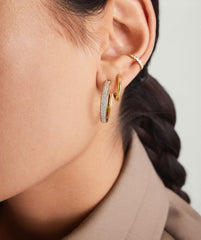 Close-up of a woman's ear wearing Bold PavÃ© Diamond Large Hoops, handcrafted in 14k solid gold with responsibly sourced diamonds.