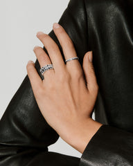 Slim Charlotte Stacker Set: A close-up of a hand wearing two silver ringsâa chunky bubble band and a scalloped band with sparkling stones.