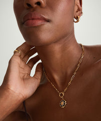 Close-up of a woman's neck wearing a handcrafted 14k gold Triple Link Paperclip Chain Charm Necklace.
