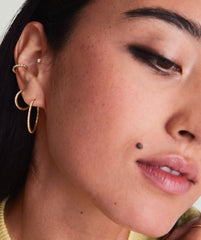 Diamond Ear Cuff: Close-up of a woman's ear adorned with a 14k gold ear cuff featuring responsibly sourced diamonds, showcasing its elegant, no-piercing-required design.