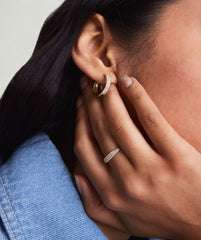 Close-up of a woman's hand wearing the PavÃ© Diamond Slim Signet, showcasing its elegant diamond detailing.