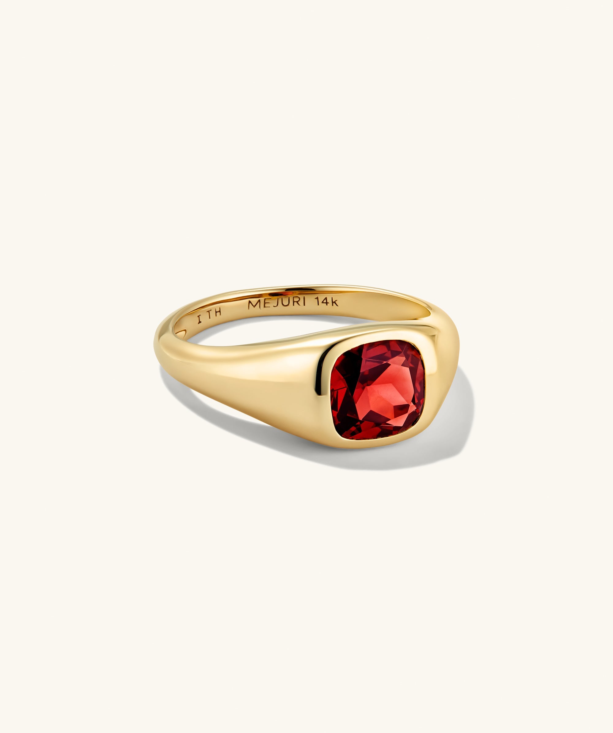 Jude Pinky Signet Ring features a cushion-cut red gemstone set in a sleek 14-karat yellow-gold band, engraved inside with MEJURI 14k.