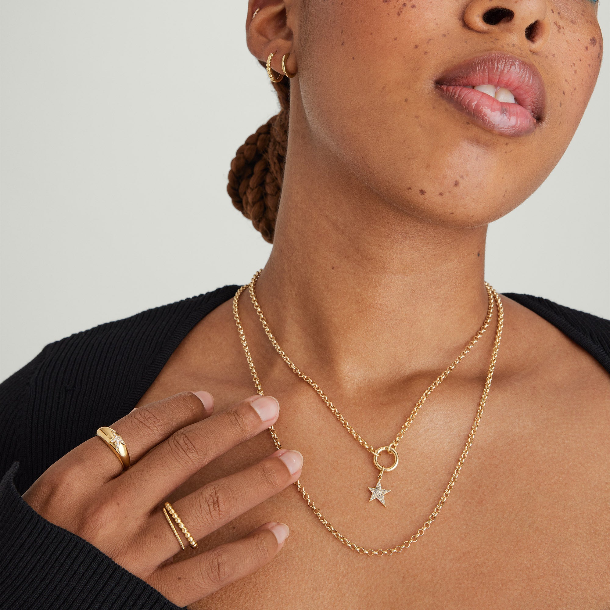 Woman wearing the Rolo Chain Charm Necklace with gold hoop earrings, showcasing the handcrafted 14k gold chain with the Stacker Clasp for layering charms.
