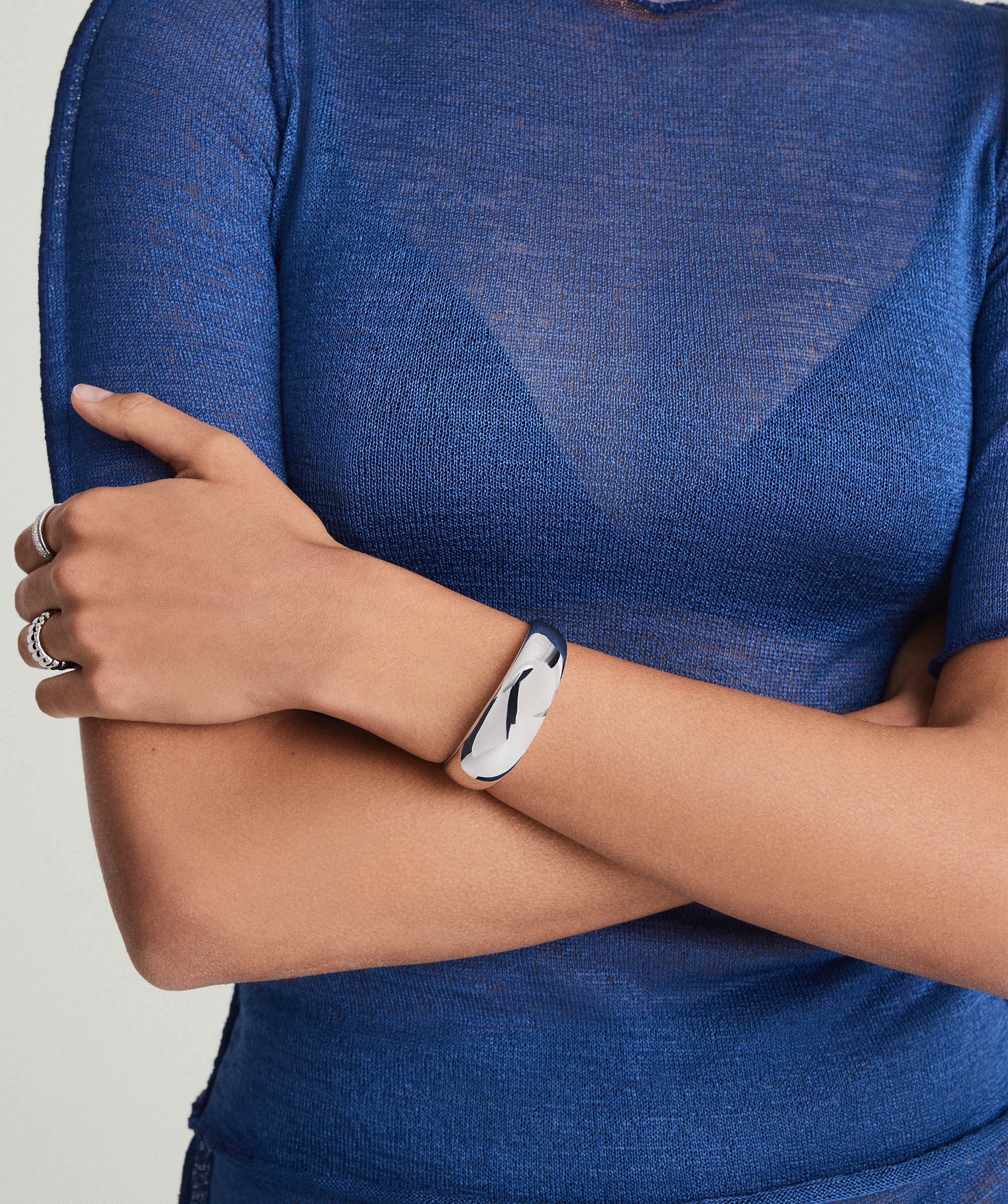 Woman wearing the 20mm DÃ´me Cuff Bracelet in 925 sterling silver, showcasing its puffed design on her wrist.