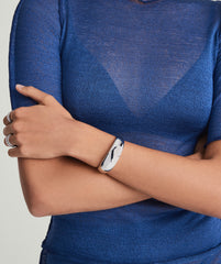 Woman wearing the 20mm DÃ´me Cuff Bracelet in 925 sterling silver, showcasing its puffed design on her wrist.