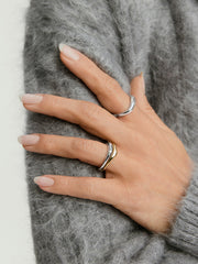 Close-up of a hand showcasing the Organic DÃ´me Nesting Ring Set, featuring two intricately designed rings that nest together as part of the DÃ´me collection.