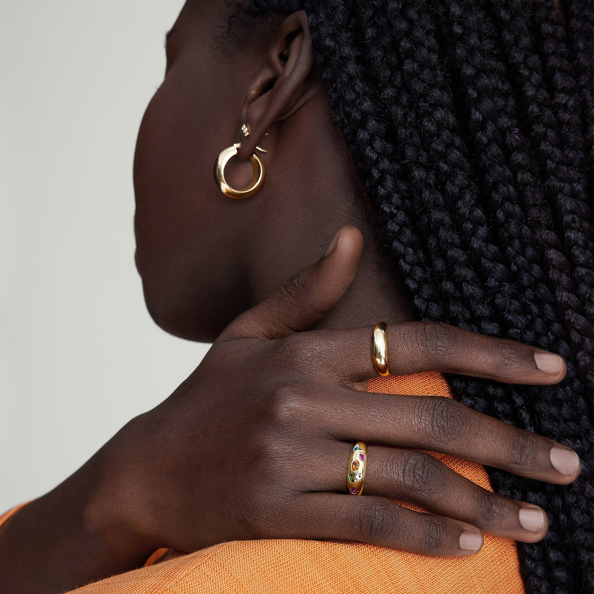 Toronto Mosaic DÃ´me Ring in 14k gold, featuring six differently cut gemstones, showcased on a woman's hand resting on her shoulder.