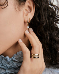 Mira Round Pearl Hoops featuring luminous mini pearls suspended from classic hoops, offering a minimal yet eye-catching design for versatile wear.