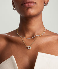 Woman wearing the Linked Two-Tone Necklace with interlinked rings, symbolizing personal bonds. The necklace is handcrafted in sterling silver and gold vermeil.